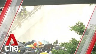 Hong Kong police fire water cannons and tear gas at protesters outside Legislative Council