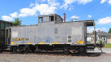 CSX Mixed Freight Train With A Caboose in the Rear