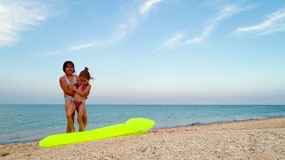 Little Sisters Practice Gymnastics On The Seashore