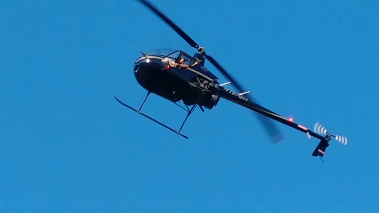 two helicopters flying in the sky together YouTube