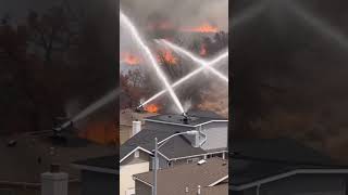 Wildfire spreading across the hills near residential areas
