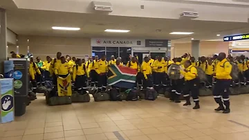 South African firefighters sing and dance after arriving at Edmonton's airport