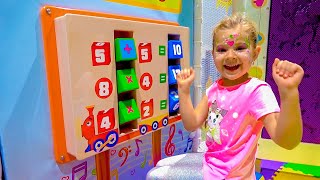 Diana and Roma interact with fun exhibits at the children's museum