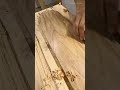 Shaving a long wooden board smoothly with a manual block plane tool to create lots of shavings