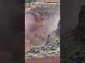 Water and mud rush down hillside in Utah