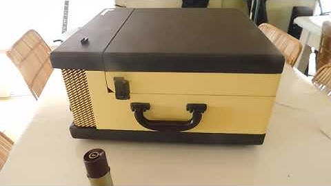 Voice of Music 4 speed automatic portable record player playing an LP record.