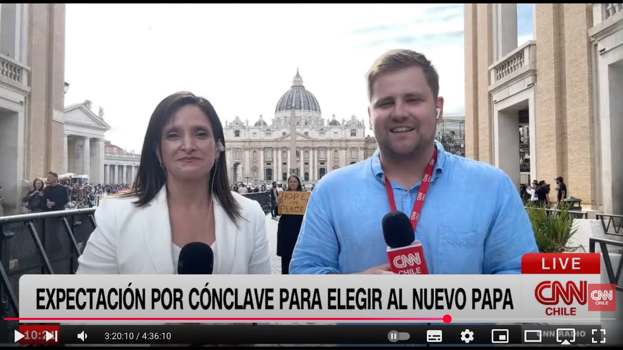 Yona Tukuser holds a "HOPE FOR PEACE" sign in St. Peter's Square at the Vatican during the Conclave