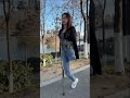 Lanzi OOE amputee in jeans crutching through the park