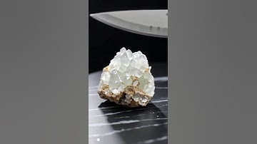 Super-sharp knife slices obsidian, quartz, sapphire, emerald, jade, diamond in slow motion.