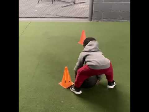 Baby doing medicine ball slams/ 