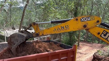 Jcb 3dx digging soil and loading into truck 