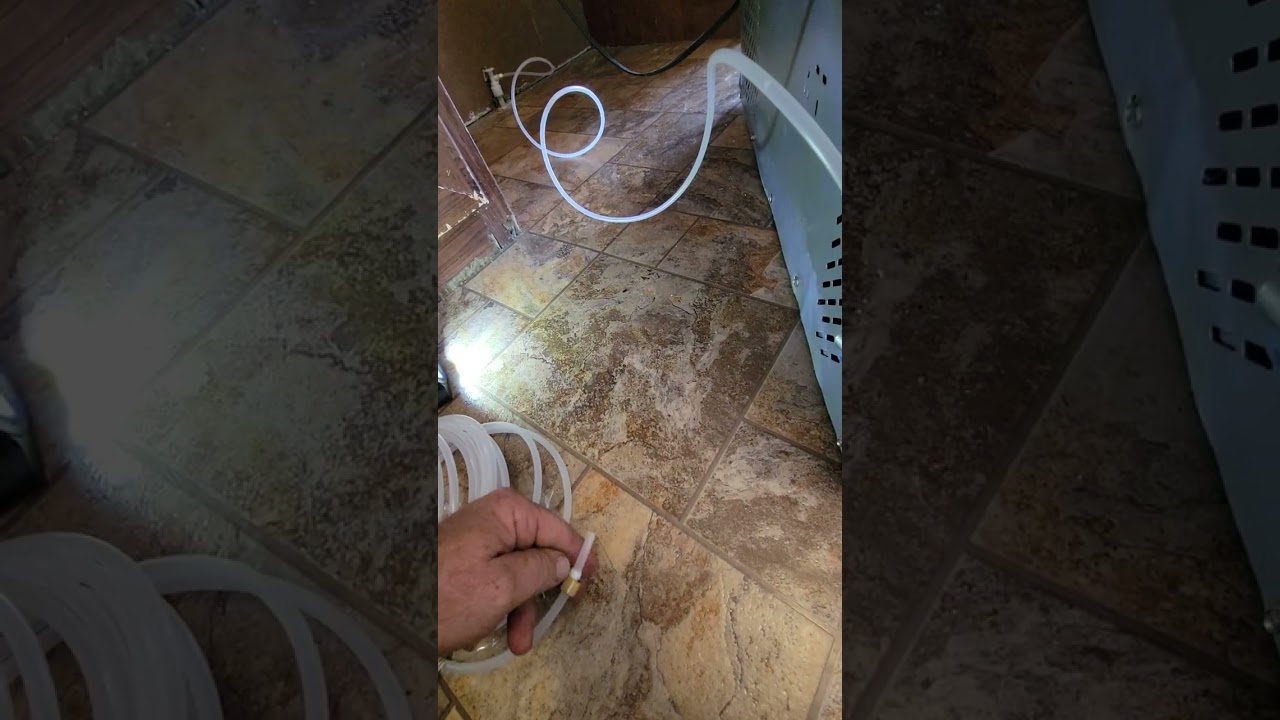 Plastic tubing installation on fridge for ice maker