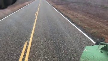 Mowing the highways with The song Footprints on the moon by Tracy Lawrence