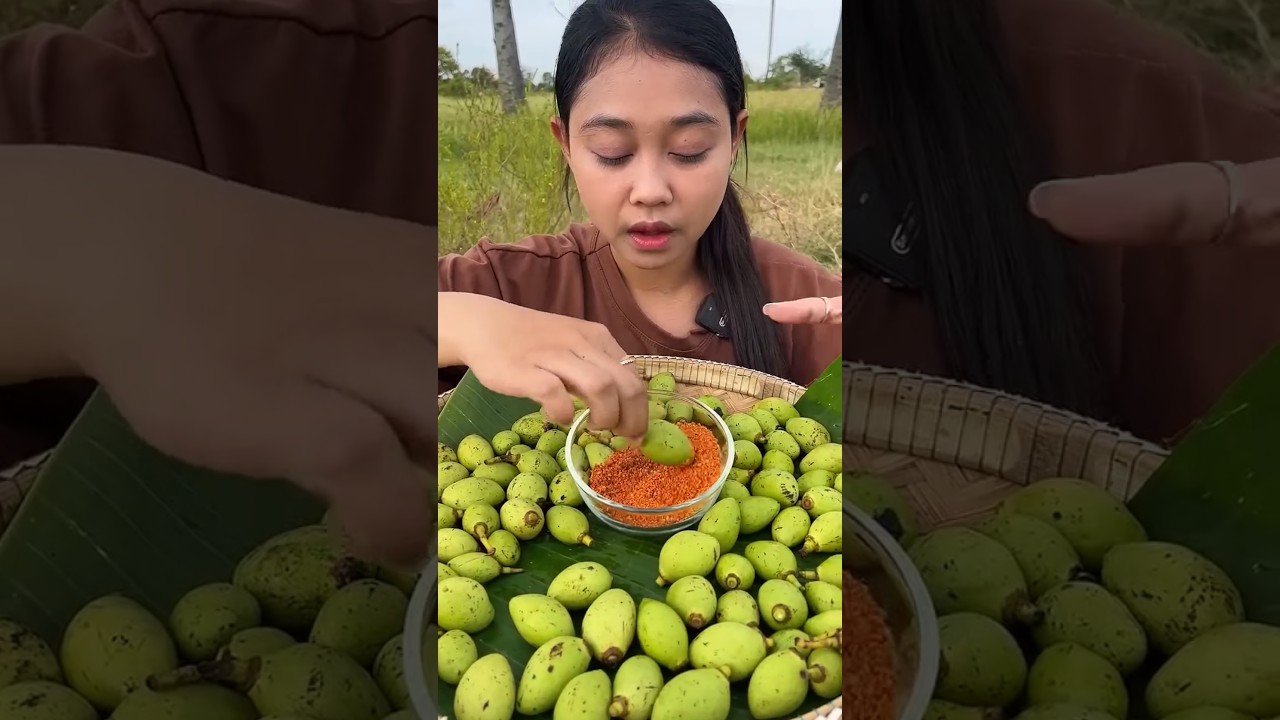 Eating tiny mango with dry spicy salt
