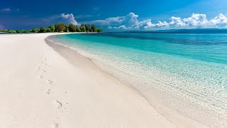 Calm sea surface, white sand, blue sky with white clouds, gentle sound of waves, relaxation , yoga.