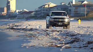 Truck driving on beach at Deer Lake State Park, FL