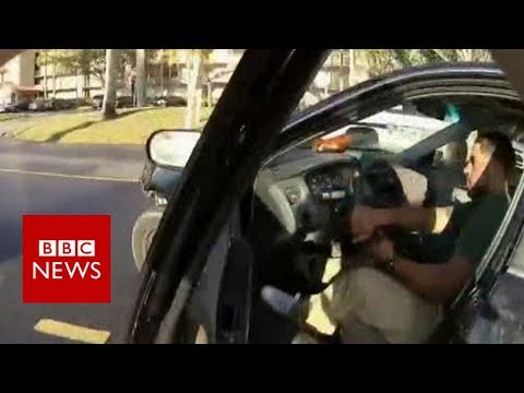 US police officer's bodycam records him clinging to speeding car - BBC News