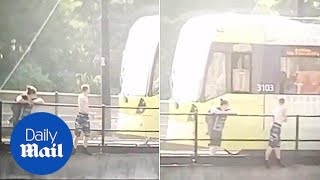 Shocking moment tram driver talks teens out of bridge jump game - Daily Mail