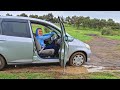 car stuck desrt tires spinning wheel wet grass pedalpumping