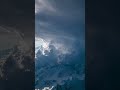 Celestial Storm: The Incredible Dance of Clouds Above Snowy Peaks