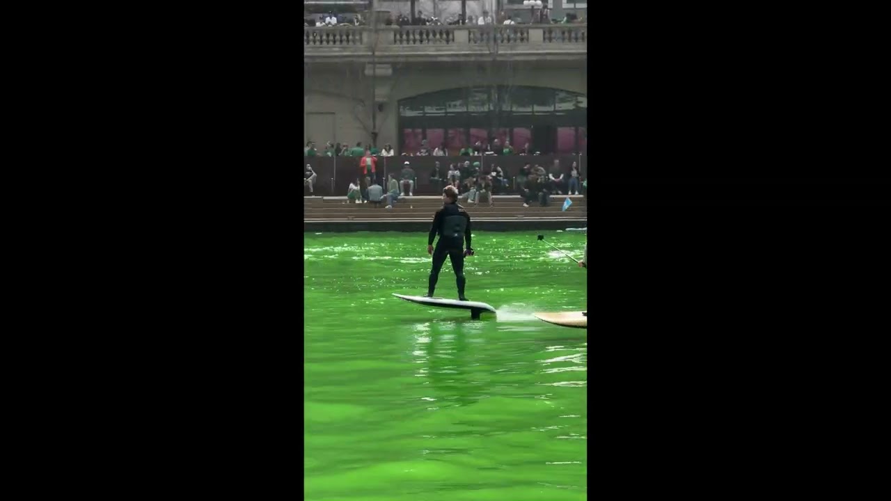 Hydrofoil Surfers Show Off on Chicago River Turned Green for St Patrick's Day