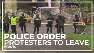 Police officers ask protesters to leave Portland State library or risk being arrested