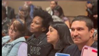 Anti-ICE signs at Tarrant County Commissioners meeting
