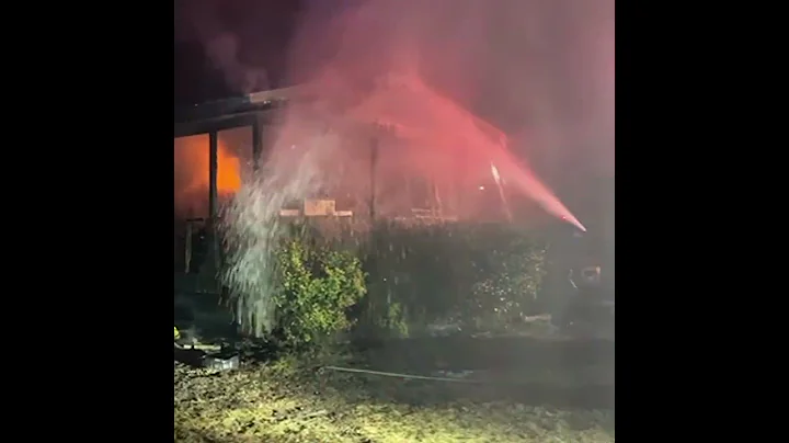 Firefighters battle a house fire that sent two people to the hospital