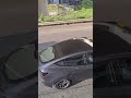 A grey tesla was driving on a Hong Kong Highway