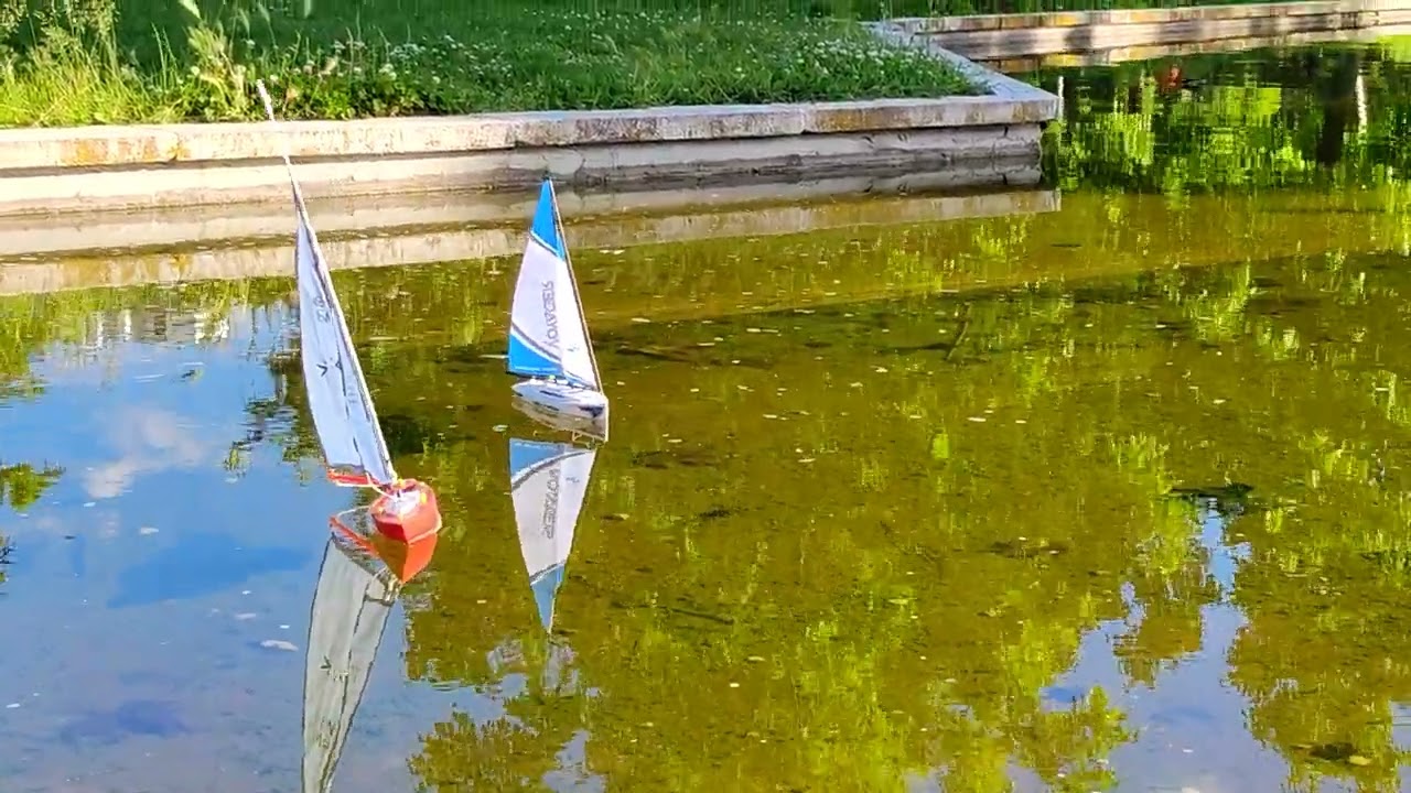 ⁣Tethered and Rc sailboat share(?) pond