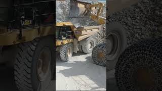 Caterpillar Wheel Loader Loading Caterpillar Dumpers - Aerial View