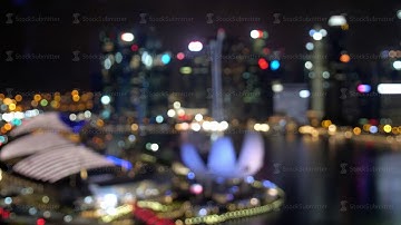 Abstract blurred light with office building and reflection night view on Singapore. changes focus to