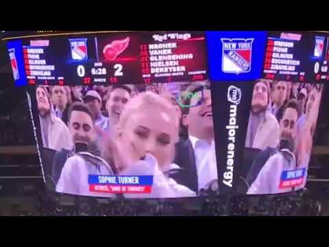 Sophie Turner slamming red wine at a hockey game