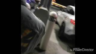 Migos show out there cars and stand on a gas station shop counter and dance.