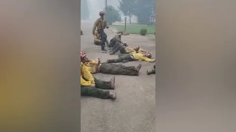 Exhausted firefighters sing together after a 14-ho...