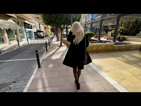 Shopping in Marbella with black nylon stockings, suspender belt, minidress and black boots in 4K