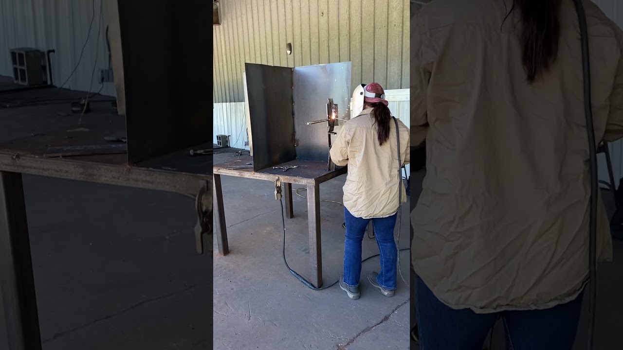 Welding vertical up fill pass on an open butt bevel plate at National Welding Academy.