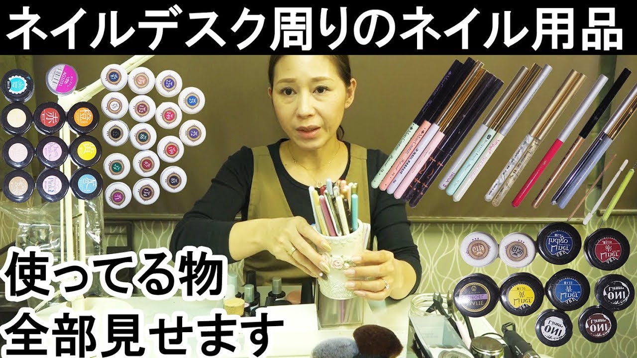 Nail supplies around nail desk [14 gels, parts, and items with