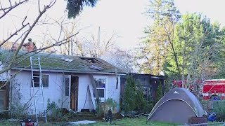 Crews battle fire at cluttered SE Portland home