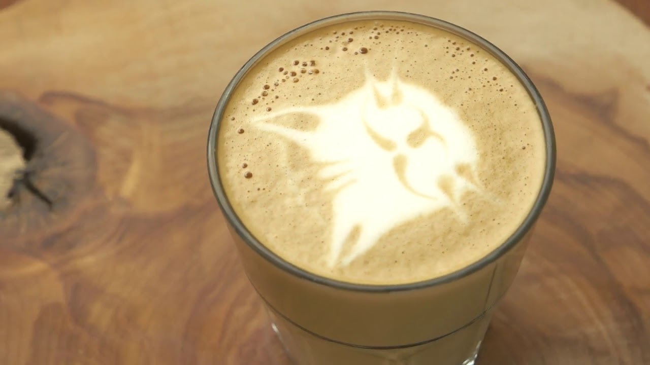 latte glass with cat art coffee on wooden board spinning cute and tasty