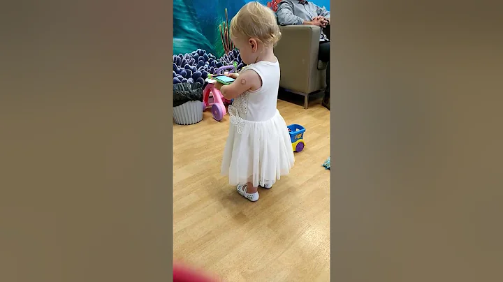 Daddy is watching his girl dance with mummy teachi...