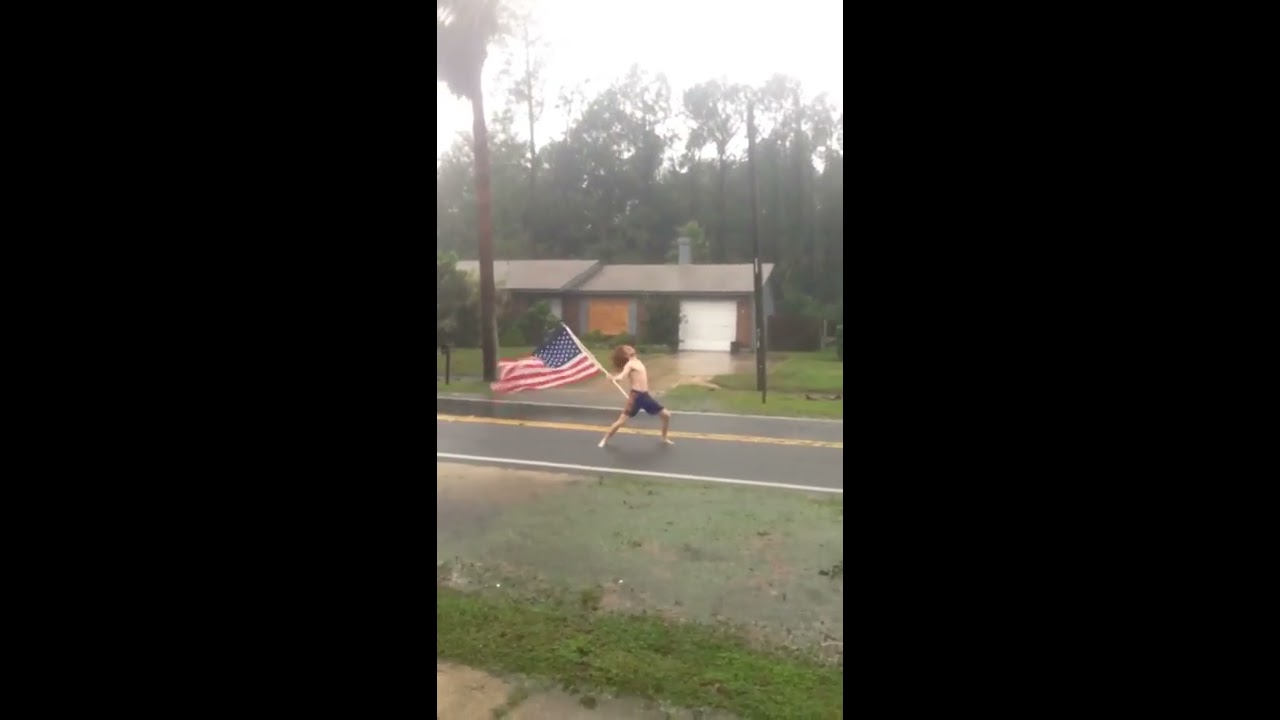 Florida Man waves American Flag during Hurricane Matthew
