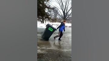Logan getting blown away in the Wind bringing in the garbage can. LOL