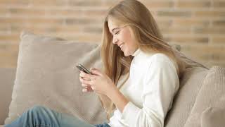 FOOTAGE People Beautiful Attractive Girl Brick Wall Phone Smile Writing Looking