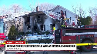 Woman rescued, hospitalized as massive fire burns through two-story house