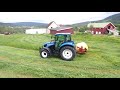 New Holland T4.75   moving grass