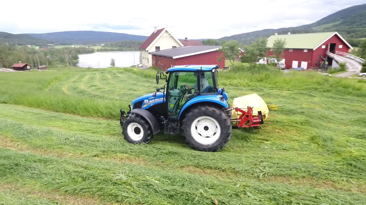 New Holland T4.75   moving grass