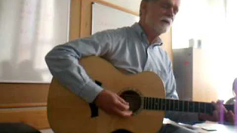 Dr. Driskill playing guitar