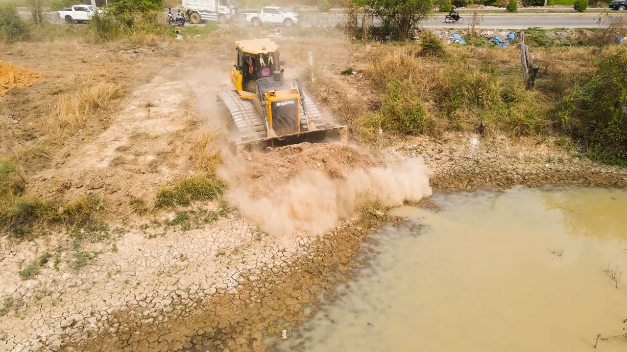 Large Machines SHNTUI Moving Dirt Close To The Big Road With Small Dump