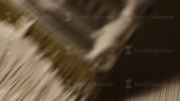 paint wooden Board in white color with brush, close-up, macro